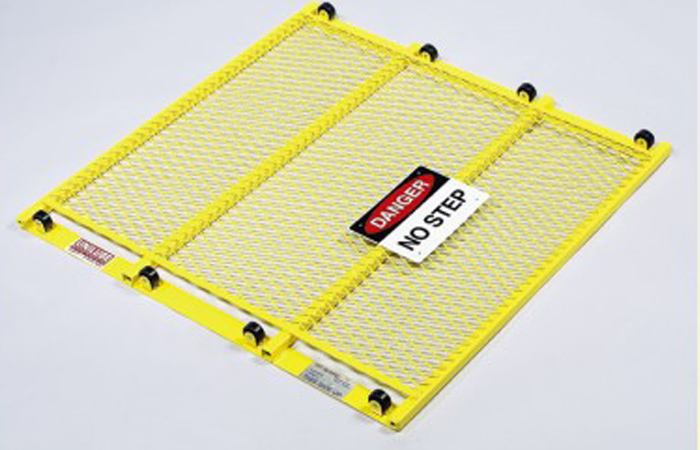 Unilube pit guard installed over a quick lube bay for OSHA compliance and shop safety